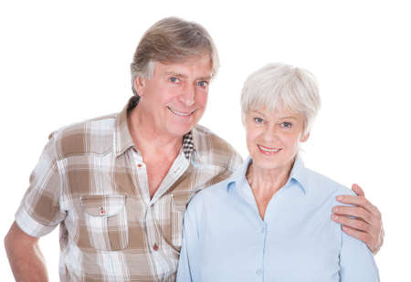 Portrait Of Senior Couple Smiling Over White Background