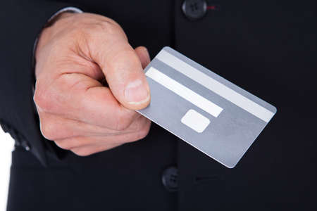 Close-up Of A Businessman In A Suit Holding Credit Card