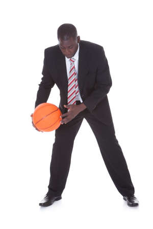 Portrait Of Young African Businessman Playing Basketballの写真素材