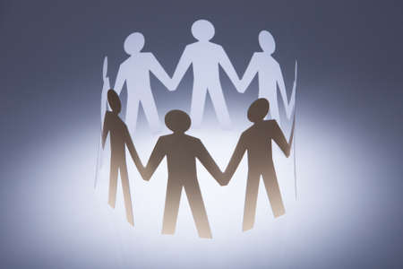 People Cut Out Of Paper Holding Hand Togetherの写真素材