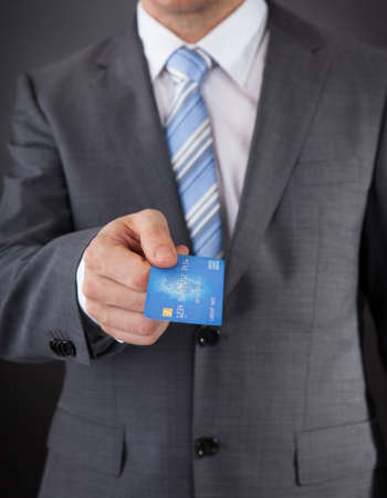 Close-up Of Businessman Giving His Credit Card の写真素材