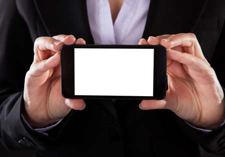 Close-up Of Businessperson Showing Blank Screen Mobile Phoneの写真素材