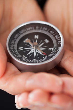 Close-up Of Businessperson Holding Compass In Handの写真素材