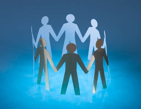 People Cut Out Of Paper Holding Hand Togetherの写真素材