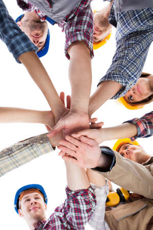 Large group of construction worker stacking hands. Isolated on whiteの写真素材