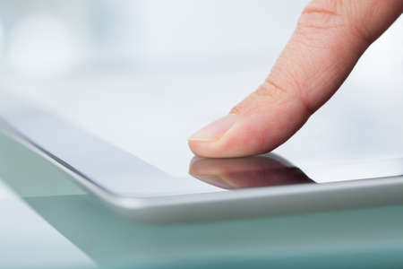 Cropped image of hands using digital tabletの写真素材