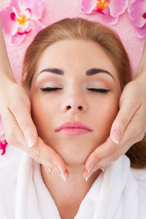 High Angle View Of Young Woman With Eyes Closed Getting Massageの写真素材