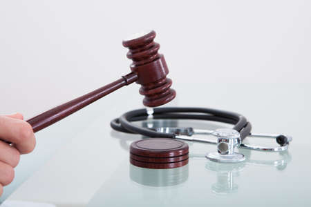 Judges gavel and a stethoscope in a conceptual image of a judgment in a medical malpractice claimの写真素材