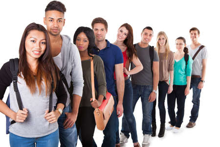 Portrait of multiethnic college students standing in a line over white background
