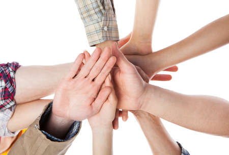 Large group of construction worker stacking hands. Isolated on white