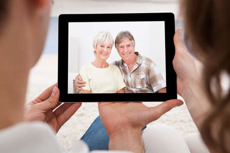 Loving couple having online video conference at homeの写真素材