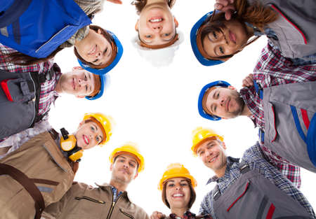 Large group of construction workers standing in circle. Isolated on whiteの写真素材