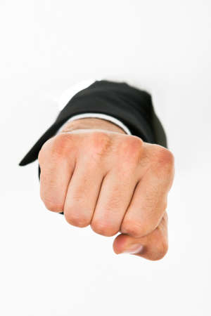 Businessman's hand punching through white paper wallの写真素材