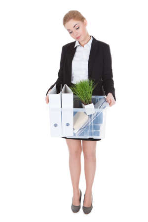 Exhausted Young Businesswoman Holding Basket Over White Backgroundの写真素材