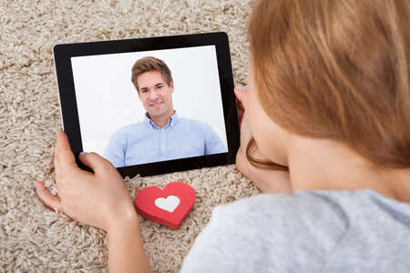 Close-up Of Young Woman Having Video Chat On Digital Tablet