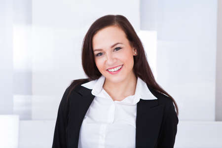 Portrait of welldressed young businesswoman standing in office