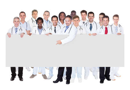 Large group confident doctors standing against white backgroundの写真素材