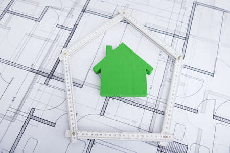 Closeup of house in folding ruler on blueprintの写真素材