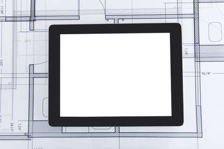 Closeup photo of digital tablet on blueprintの写真素材