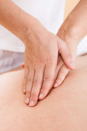 Cropped image of woman massaging man's back in spa