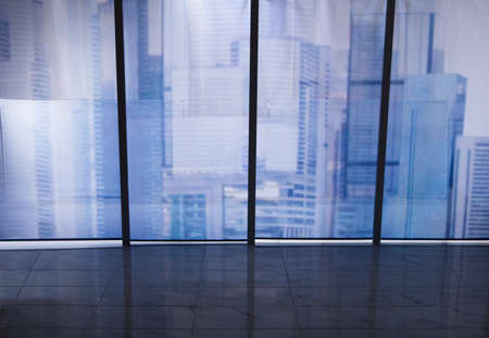 View of cityscape through transparent office windowの写真素材