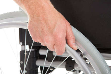 Closeup of disabled man in wheelchair over white background