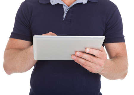 Midsection of man using digital tablet over white backgroundの写真素材