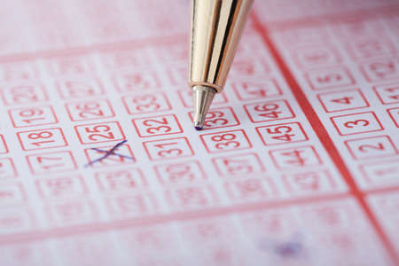 Closeup of pen marking numbers on lottery ticketの写真素材