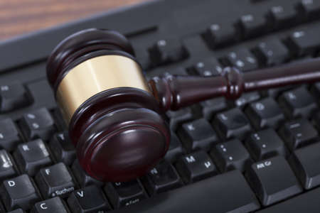 Closeup of mallet on computer keyboard in courtroom