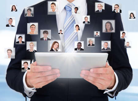 Collage of business people with businessman using digital tablet representing global communicationの写真素材