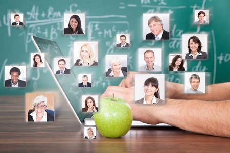 Collage of business people with hand using laptop by green apple representing global communicationの写真素材