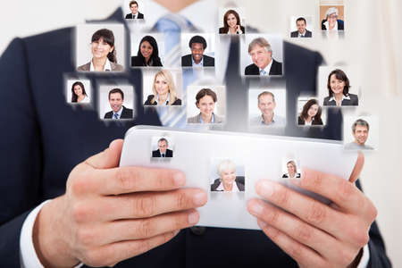 Collage of business people with businessman using digital tablet representing global communicationの写真素材