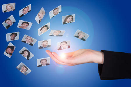 Closeup of businesswoman's hand with photographs over blue background