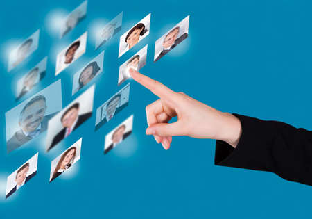 Cropped image of businesswoman selecting candidate on digital interface over blue backgroundの写真素材
