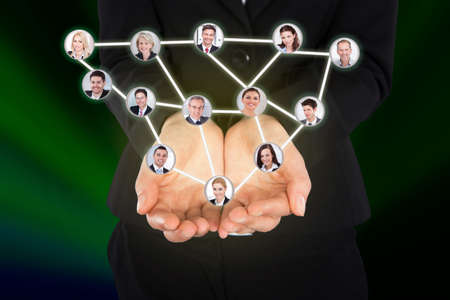 Digital composite image of businesswoman holding connected team representing leadershipの写真素材