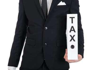 Midsection of young businessman holding Tax folder against white backgroundの写真素材