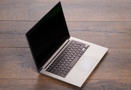 Photo of ultra portable laptop on wooden table