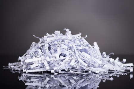 Pile of shredded documents over black backgroundの写真素材