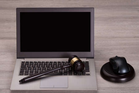 Photo of judge gavel on laptop computer keyboardの写真素材