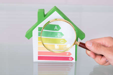 Inspecting new eco friendly house using magnifying glassの写真素材