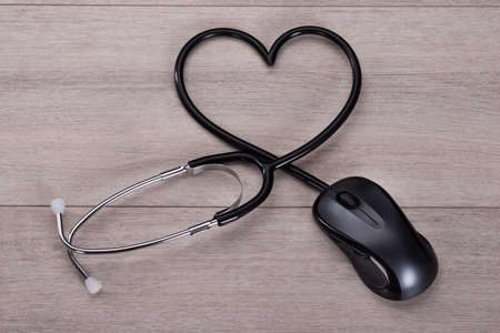 Stethoscope forming heart shape in online medical advice conceptの写真素材