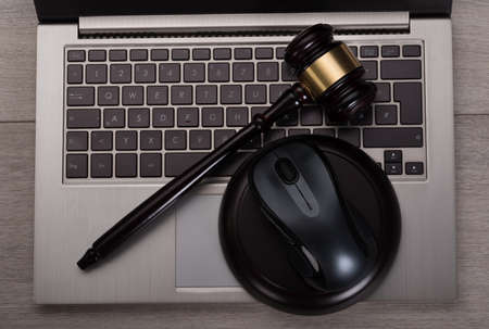 Photo of mallet lying on computer keyboardの写真素材