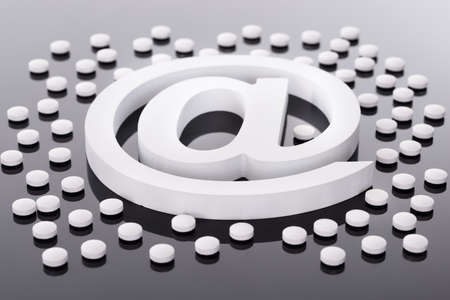 At Internet Symbol and Medicine Pills on Blackの写真素材
