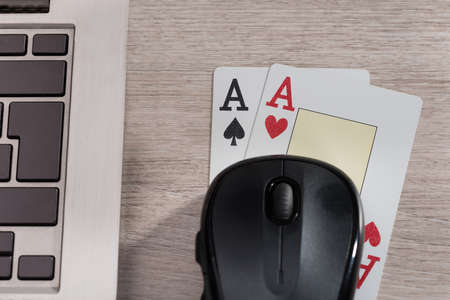 Playing cards and computer in online gaming concept