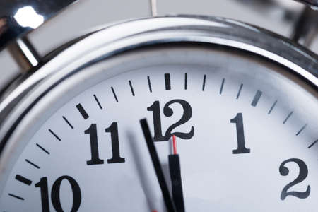 Closeup photo of alarmclock. Almost noon timeの写真素材