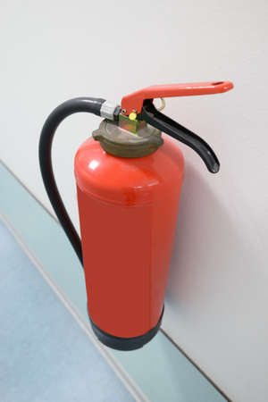 Close-up Of Red Fire Extinguisher Mounted On Wallの写真素材