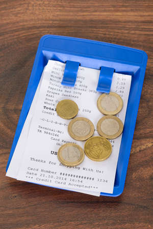 Close-up Of Bill And Tip On Wooden Table In CafÃ©の写真素材