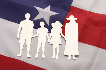 Close-up Of Family Paper Cut-out On American Flagの写真素材