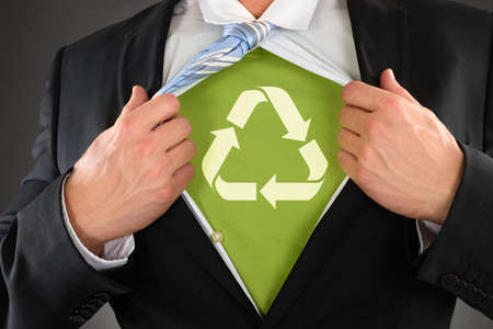 Close-up Of A Businessman Showing Recycled Symbol Under His Shirtの写真素材
