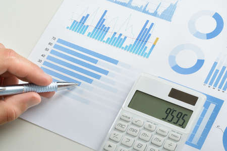 Businessman With Pen Over Graph Doing Calculations